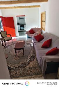 a living room with two beds and a table at Firehouse self-catering cottage 7 in Wellington