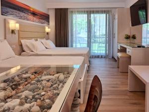 a hotel room with two beds with a aquarium in the floor at Valentinos House in Parga