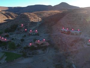 an aerial view of a house in the desert at Zebra River Lodge in Maltahöhe +3 photos