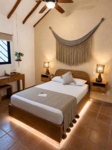 a bedroom with a large bed in a room at Hotel Casa Colibri in Playa del Carmen