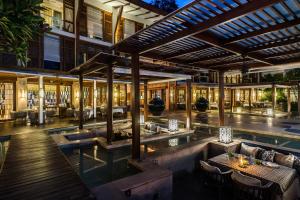 an outdoor dining area with tables and chairs and a building at InterContinental Hua Hin Resort by IHG in Hua Hin