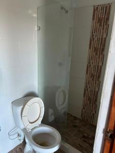 a bathroom with a toilet and a glass shower at Villa Magdalena y Puerto Perales in La Piedad +24 photos