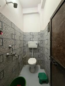 a small bathroom with a toilet and a shower at Shri Raghuveer guest house in Ayodhya