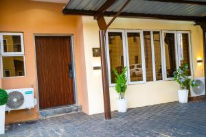 a front door of a house with potted plants at CozyKeys luxurious Apartment in Abuja