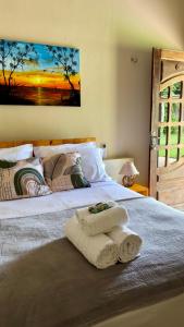 a bedroom with a bed with two towels on it at The Jungle, Guriú, CE in Guriú +76 photos