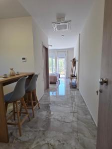 a living room with a table and chairs and a camera at BLV Apartments in Tsoukalades