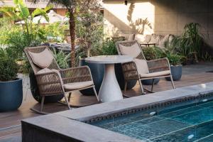 a group of chairs and a table next to a pool at Four Hills Hotel in Antalya