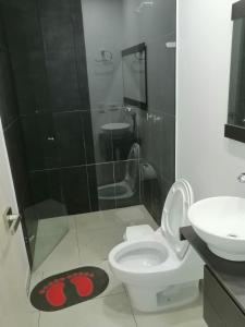 a bathroom with a shower and a toilet and a sink at Modern apartment with pool-La Mesa in La Mesa