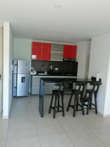 a kitchen with a table and chairs and a refrigerator at Modern apartment with pool-La Mesa in La Mesa