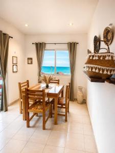 a dining room with a table and a view of the ocean at Hotel Isla Mujeres Centro & Beach Club Included in Isla Mujeres