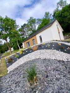 a house with a stone path in front of a building at Gîte Chalet Bellevue in Couvin