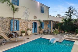 a villa with a swimming pool in front of a house at Villa Epavlis in Plaka
