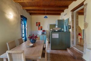 a kitchen with a wooden table in a room at Villa Epavlis in Plaka