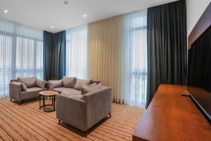 a living room with a couch and a pool table at Jizzax Hotel Tashkent in Tashkent