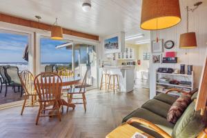 a living room with a couch and a table with chairs at Coastal Coziness in Cayucos