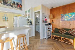 a kitchen and living room with a bar and a couch at Coastal Coziness in Cayucos