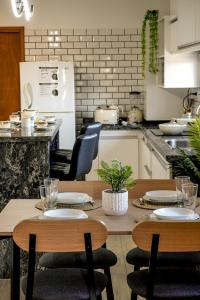 a kitchen with a table and chairs and a refrigerator at Departamento a estrenar a pasos del pulmón de la cuidad in San Nicolás de los Arroyos
