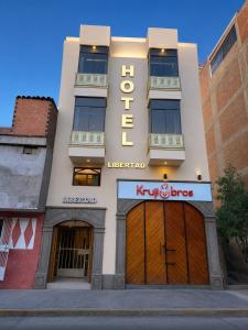 a building with a hotel sign on the side of it at Libertad Grand Hotel in Ayacucho