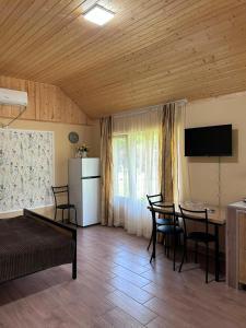 a living room with a dining room table and a kitchen at KOTE.GE in Lagodekhi