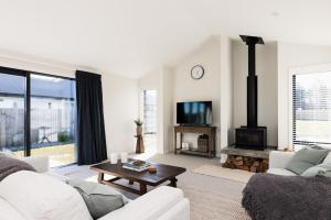 a living room with a couch and a fireplace at Alpine Retreat in Methven