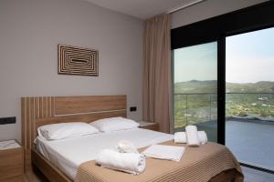 a bedroom with a bed with towels on it at Aifantis Villa 1 in Póndi +79 photos