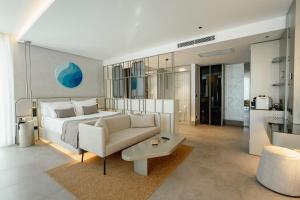 a bedroom with a bed and a couch and a table at Four Hills Hotel in Antalya +104 photos