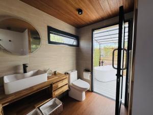 a bathroom with a sink and a toilet and a mirror at Private Sunset Beachfront Thainee Villa in Nathon Bay +99 photos