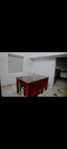 a wooden table in the middle of a room at Corniche inn river view villa 2 BHK in Kāsaragod