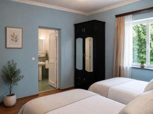 a bedroom with two beds and a mirror at Teo Guesthouse and Camping in Mestia in Mestia
