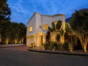a large white house with lights on a street at La Toscana del Poblado in Medellín