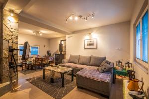 a living room with a couch and a table at Villa Stefan Kozuf in Konsko
