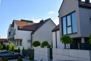 a car parked in front of some houses at Cobalt Apartments in Mikołajki