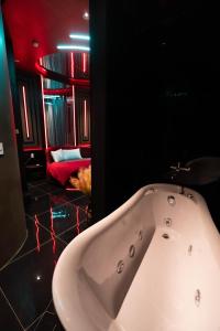 a bathroom with a white bath tub in a room at Mia Hotel in Ga Trảng Bôm +42 photos