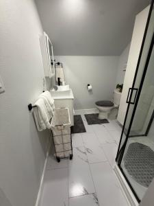 a white bathroom with a sink and a toilet at Gorgeous Home in Prime Location in Sauk City +39 photos