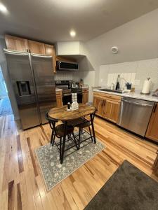 a kitchen with a table and stainless steel appliances at Gorgeous Home in Prime Location in Sauk City