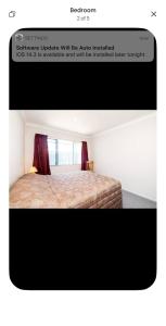 a screenshot of a bedroom with a bed in a room at The Napier Stay in Napier