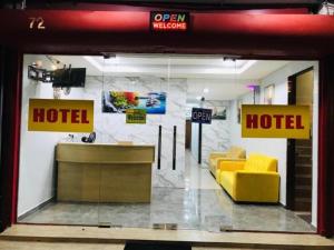 a hotel lobby with a yellow couch in a room at Georgetown New Wave Hotel in George Town