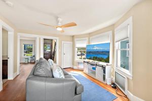 a living room with a couch and a tv at Old Tacoma Victorian Main Floor Duplex Unit in Tacoma