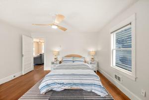 a bedroom with a bed and a ceiling fan at Old Tacoma Victorian Main Floor Duplex Unit in Tacoma