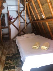 a bedroom with a bed in a wooden room at La aldea in Capurganá