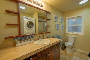 a bathroom with a sink and a washing machine at Old Tacoma Victorian Main Floor Duplex Unit in Tacoma +83 photos
