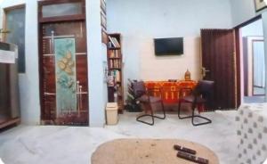 a living room with a table and chairs and a television at Mystic Paradise in Jaipur