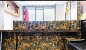 a room with a couch and a window at Hotel shree in Indore