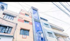 a tall building with many windows on the side of it at Hotel shree in Indore