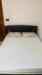 a bed with two pillows on it in a room at Calm bay in Minneriya