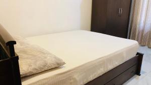 a bed in a bedroom with a wooden bed frame at Calm bay in Minneriya