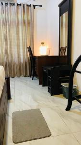 a living room with a desk and a mirror at Calm bay in Minneriya