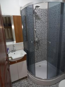 a bathroom with a shower and a sink at Roatan Onat Hostel 1 in West End