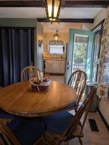a dining room with a wooden table and chairs at Serene A-frame Cabin Pet Friendly Panoramic View in Sun Valley