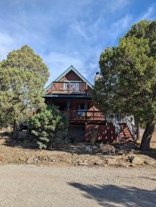 a house with a deck on top of it at Serene A-frame Cabin Pet Friendly Panoramic View in Sun Valley